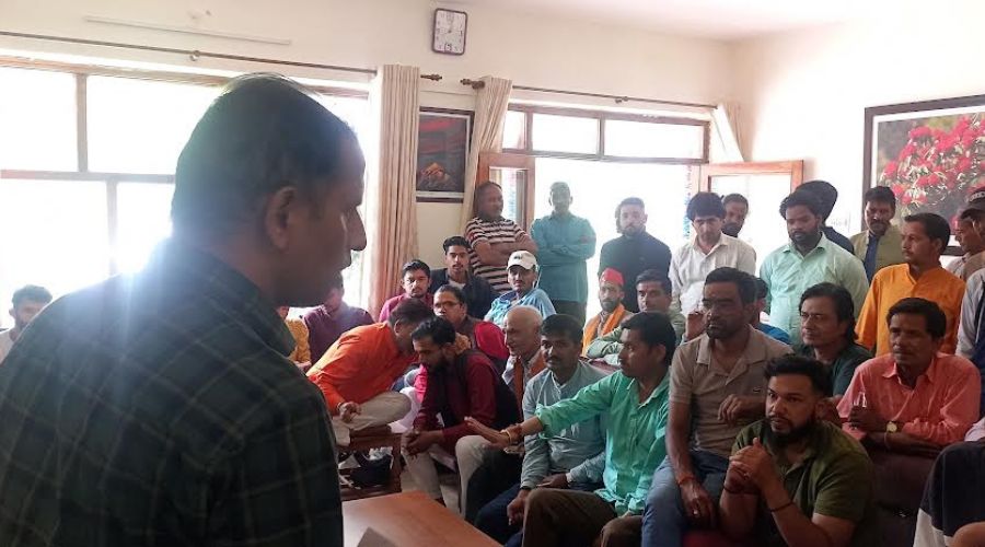Officer giving information about master plan to people in Jageshwar